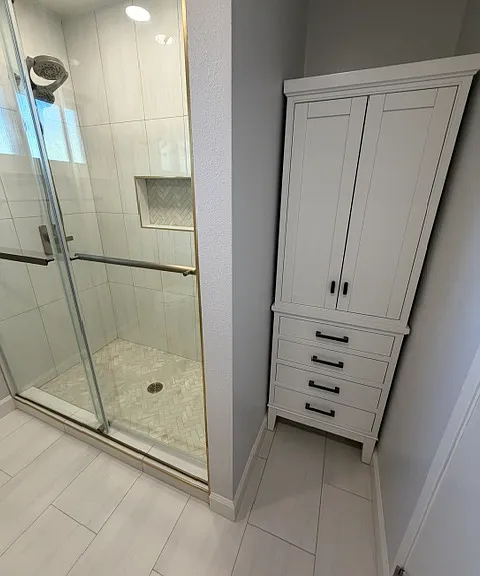 Upper floor master shower with storage cupboard. Shower is 5 feet wide and cupboard is 2 feet wide.