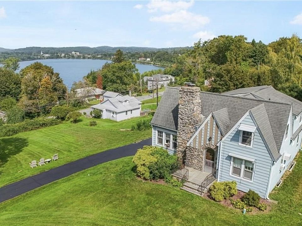 Front of House with view of lake and side yard