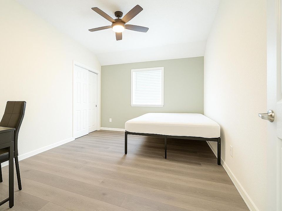 Modernly decorated bedroom featuring a full-size mattress on a raised bedframe for extra under-bed storage