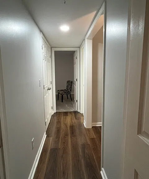 View down hallway from primary to secondary bedroom.