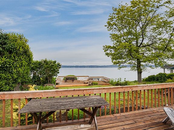 A view from the house deck, overlooking the second deck and the waterfront scenery.>