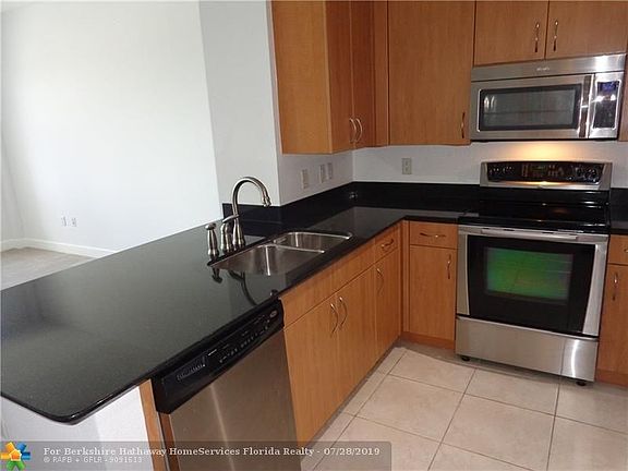 Kitchen with room for bar stools along granite counters.
