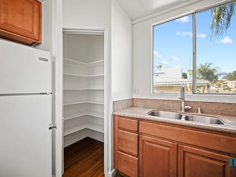 Kitchen with a Pantry Closet, refrigerator, and Large-Size Windows