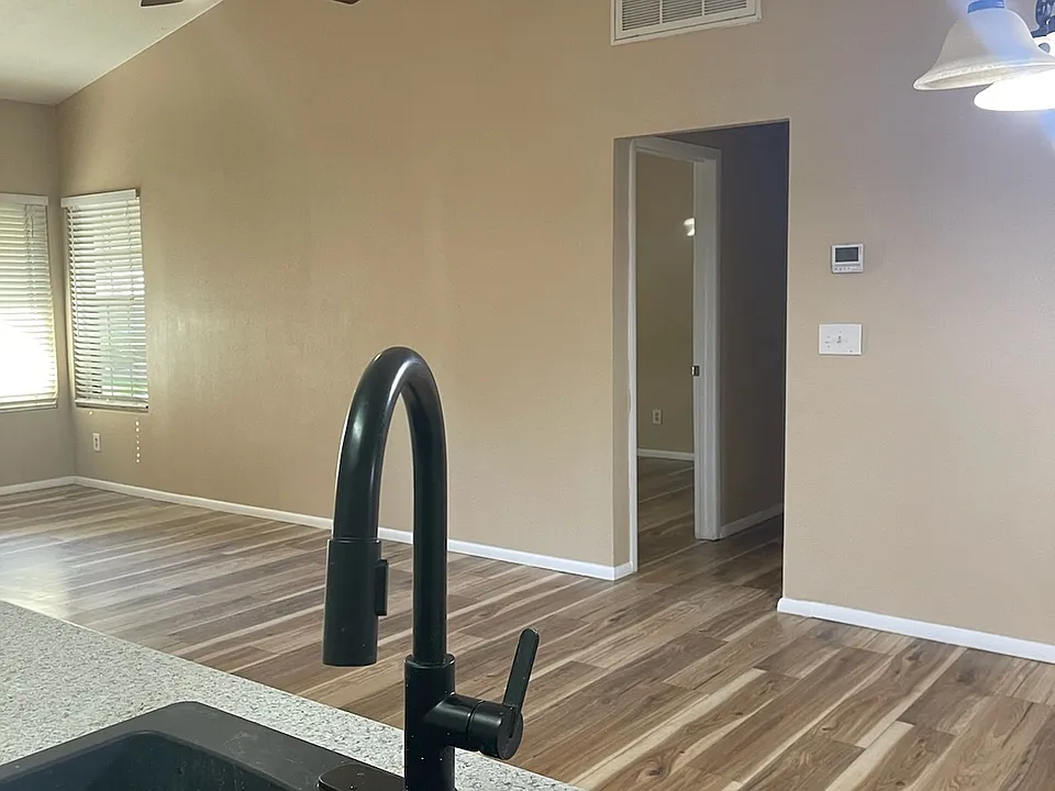 Open floor plan, kitchen island looks out at the living room and dining area