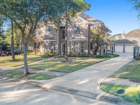 The trees offer shade to this well-manicured lawn with blooming foliage!