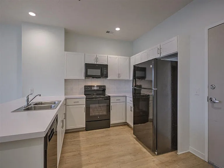 Front entrance and kitchen in a unit at The Rise.