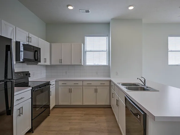 Kitchen with storage in a unit at The Rise.