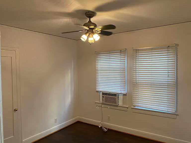 Bedroom 1 With Window A/C and Ceiling Fan