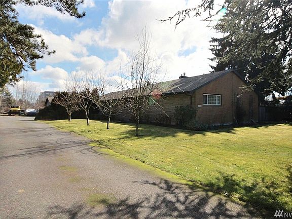 Home sits back on long, wide driveway with plenty of parking. 