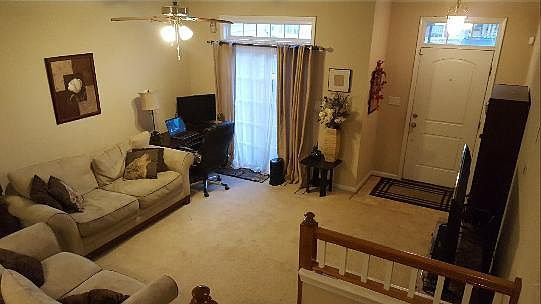 Living room. Patio door leads to fenced in patio with storage closet.