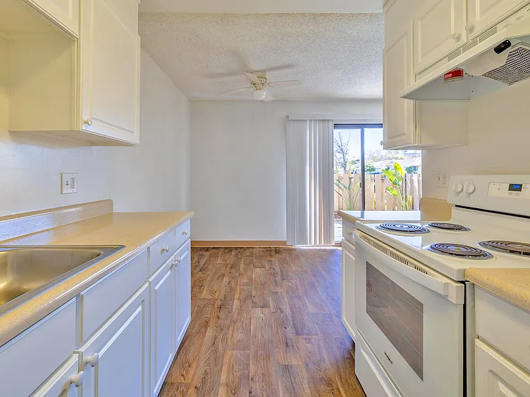 Kitchen overlooks a spacious dining area with access to a private patio.