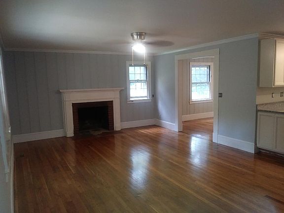 Living room, opens to kitchen and dining .