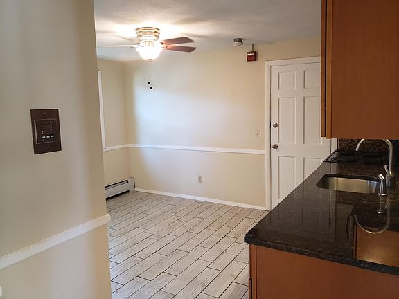 Door buzzer and kitchen viewed from hallway