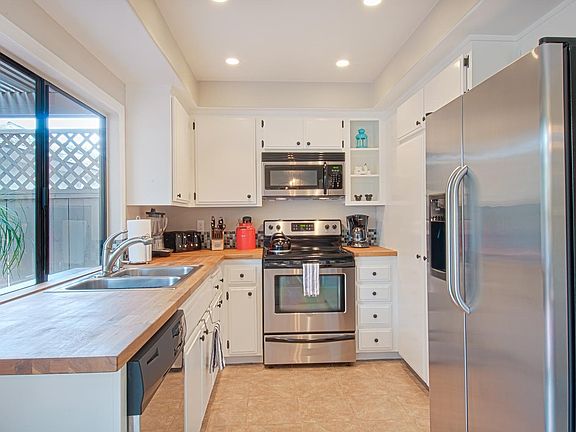 Full kitchen with butcher block countertops, all appliances, and large pantry.