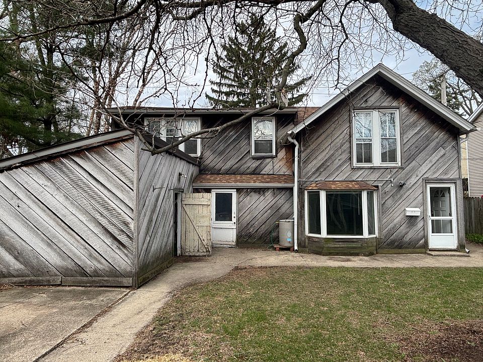coach house on right side and above garage, storage shed on left,
