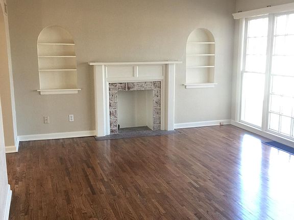Large living room with beautiful wood floors and lots of natural light.