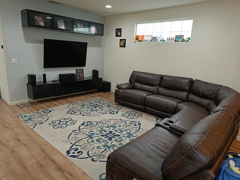 Elevate your entertainment experience with our stylish TV console - no more hanging wires! . Featuring two hanging storage cabinets _ Relax and unwind in the heart of your home _ a serene living area with a comfortable sofa and a sleek TV console. A space