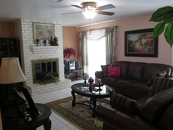 LIVING ROOM WITH DOUBLE FRENCH DOORS. UPGRADED CEILING FAN.