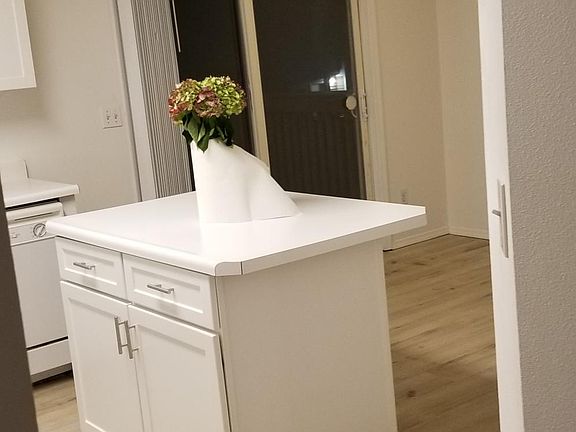 Kitchen dining area and island. Pantry to the right