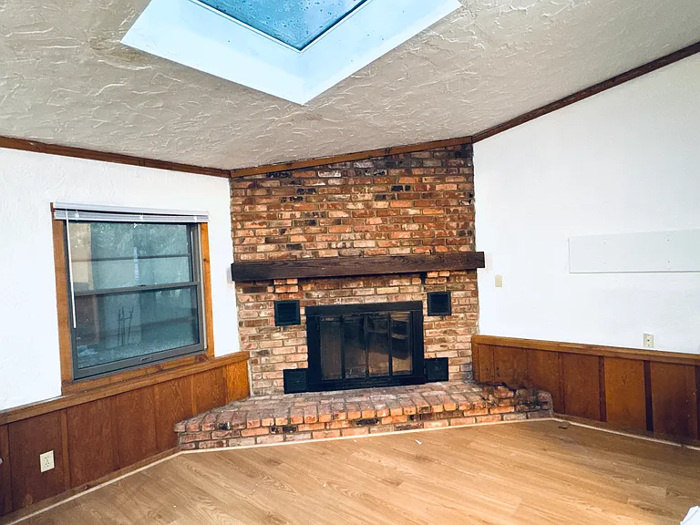 Large Family room with fire place and skylights.