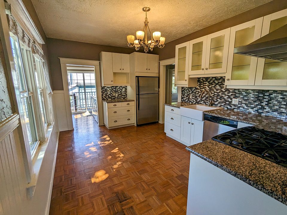 Large, eat in kitchen with granite counters, stainless steel appliances, mosaic tile backsplash, undercabinet lighting and lots of natural light.