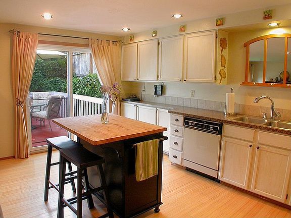 Entertain easily as sliders open from kitchen to fenced backyard & deck