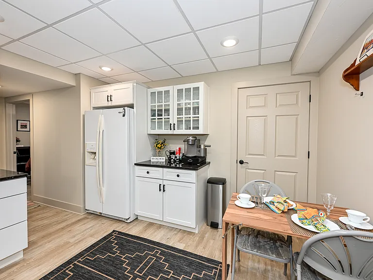 Beautiful granite countertops with coffee bar. Cabinets are fully appointed with silverware, dishes, coffee and tea cups, wine glasses, paper plates, pots and pans and bakeware.