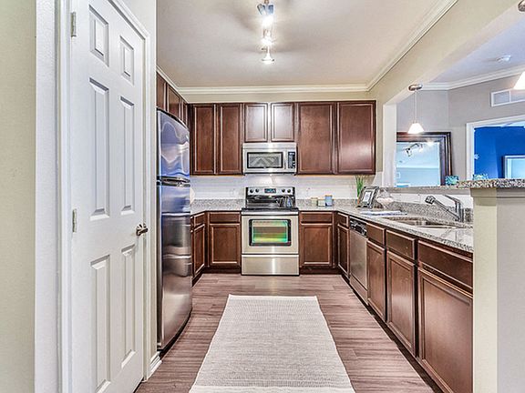 Large Eat In Kitchen with Espresso Cabinets and Stainless Steel Appliances