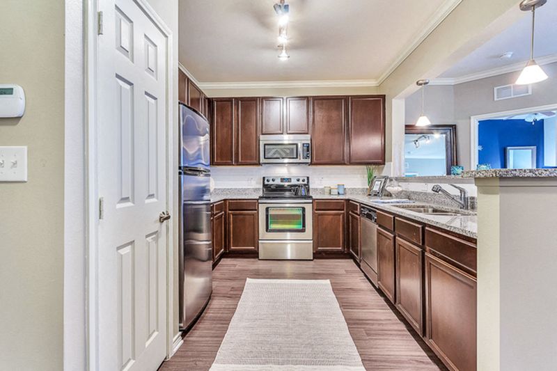 Large Eat In Kitchen with Espresso Cabinets and Stainless Steel Appliances