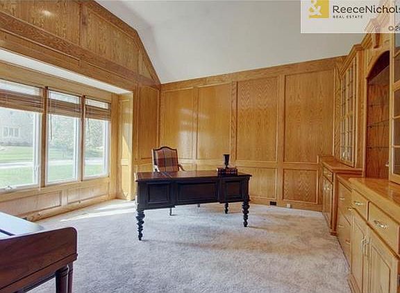 Handsomely paneled library/office with loads of built ins