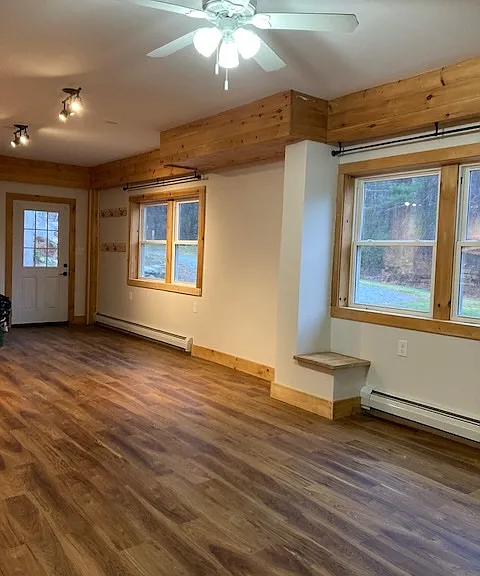 View of the living room /dinning / entry with windows towards the yard