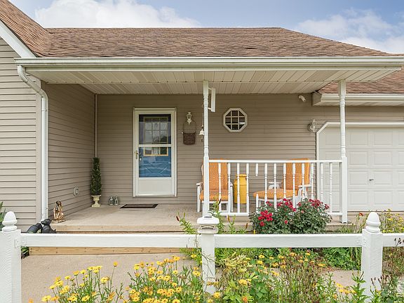 Bright and abundant flowers frame this convenient ranch home.