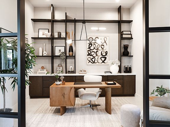 A modern and minimalist home office space with wooden furniture, shelves displaying decorative items