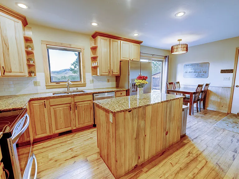 Open floor plan kitchen with bright lighting.