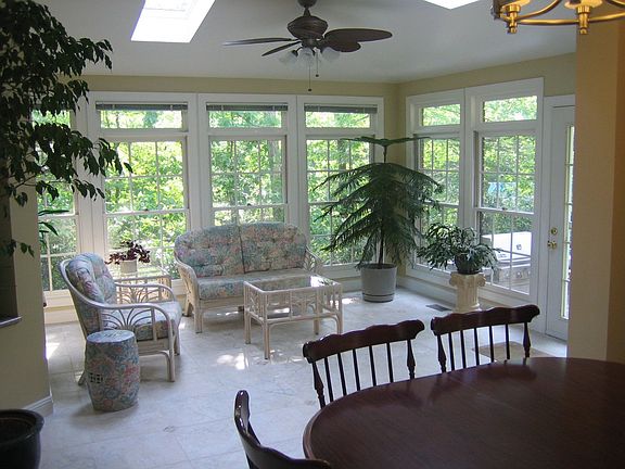 Sunroom has great view of trees and park