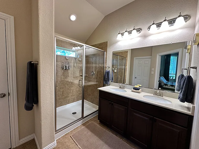 Primary bathroom with linen closet, toilet closet, and walk-in closet