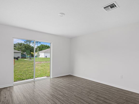 The family room is spacious and has a sliding glass door leading to the backyard