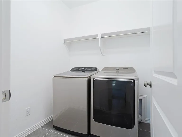 Laundry room with drip and dry hanging rods for convenient air-drying.