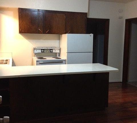 kitchen with eating bar, view to bedroom