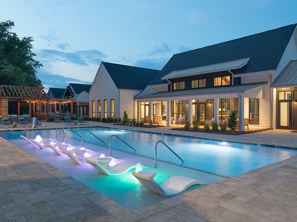 Experience tranquility and style at this luxurious poolside retreat, perfect for evening relaxation.