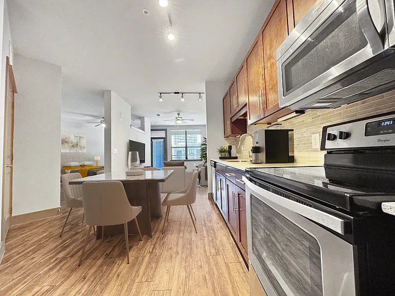 Experience contemporary living with this stylish kitchen and dining setup. Experience contemporary living with this stylish kitchen and dining setup.