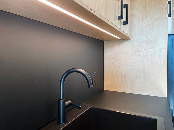under cabinet lighting, washes the locally made rich lite backsplash and countertop