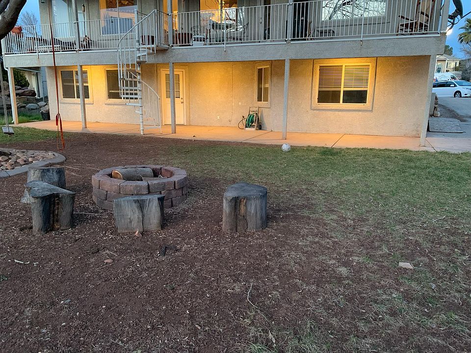 Walkout basement unit entrance, driveway, and shared backyard.