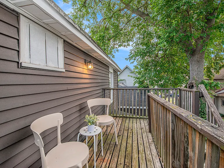 Patio furniture on back deck with access to small back yard