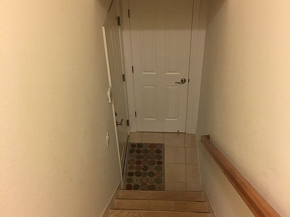 Stairs to garage-coat closet
