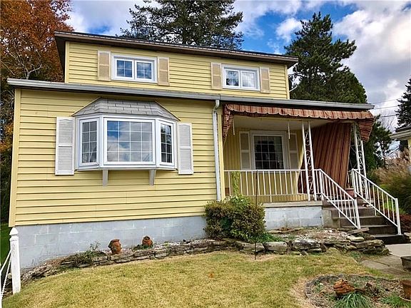 A cute Cape Cod with bay window overlooking the front yard and covered front porch complete with a custom awning.