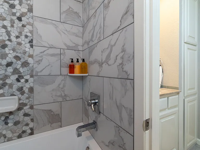 Bathroom 1 with shower/tub combo with soap/shampoo/conditioner.