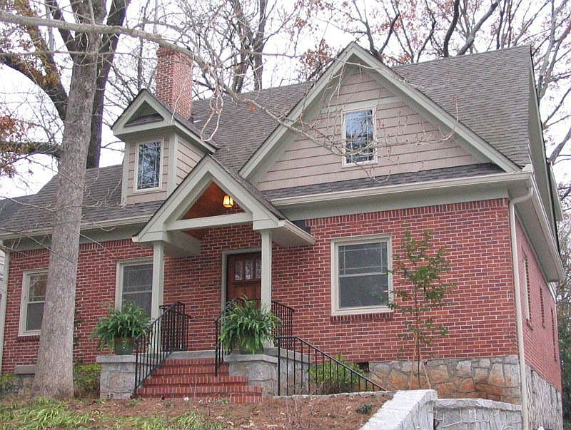 Brick + concrete shake siding + granite foundation + gutter helmets