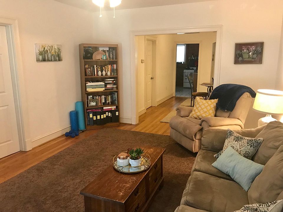 Large living room, opens to front porch on one end and the dining room on the other.