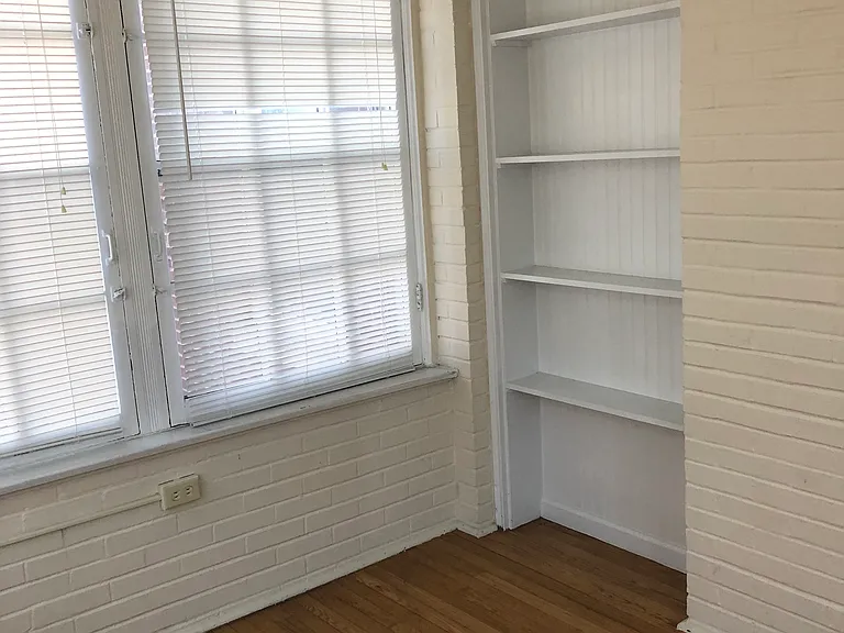 Sunroom with both heat and air conditioning, built-in shelves, and hardwood flooring. Makes a great home office or a cozy den.